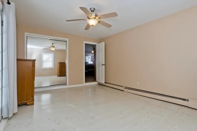 an empty room with fan and entrance