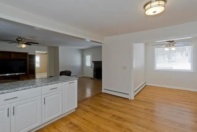 a spacious bathroom with a granite countertop sink and a mirror