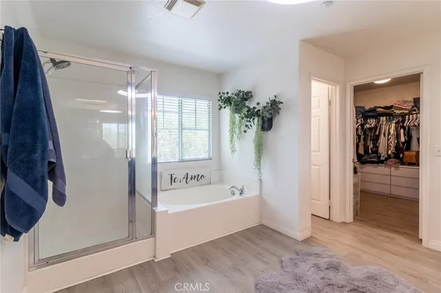 a spacious bathroom with a bathtub and a shower