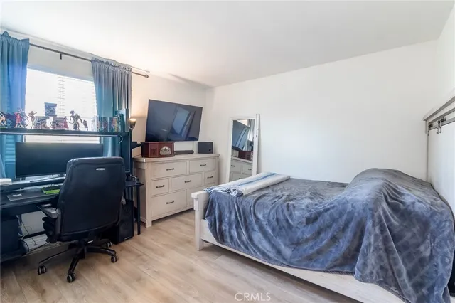 a bedroom with a large bed and a desk