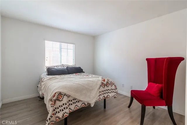 a bedroom with a bed a chair and a window