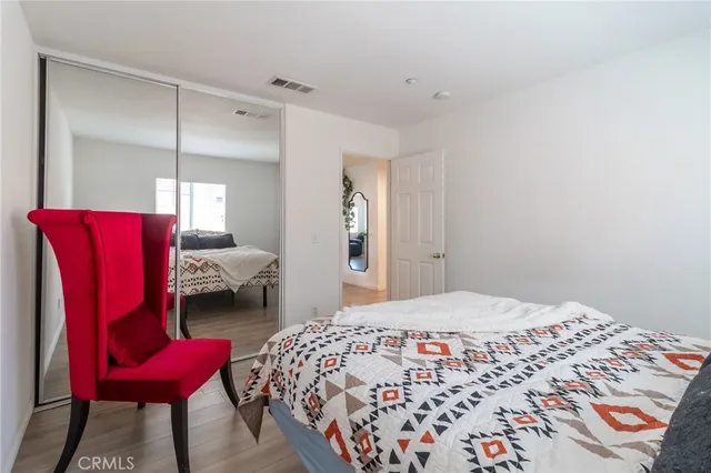 a bedroom with a bed and chair