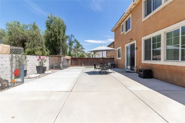 a view of a building with sitting area and furniture