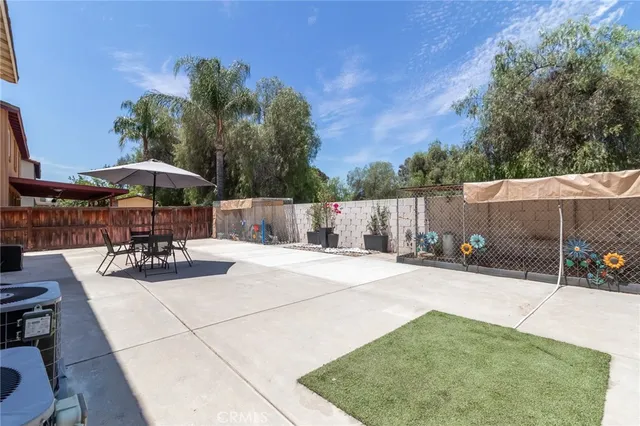 a view of a backyard with sitting area
