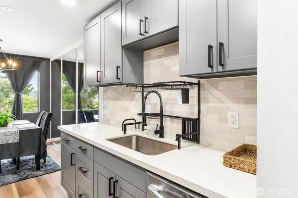 a kitchen with stainless steel appliances a sink a stove and a refrigerator