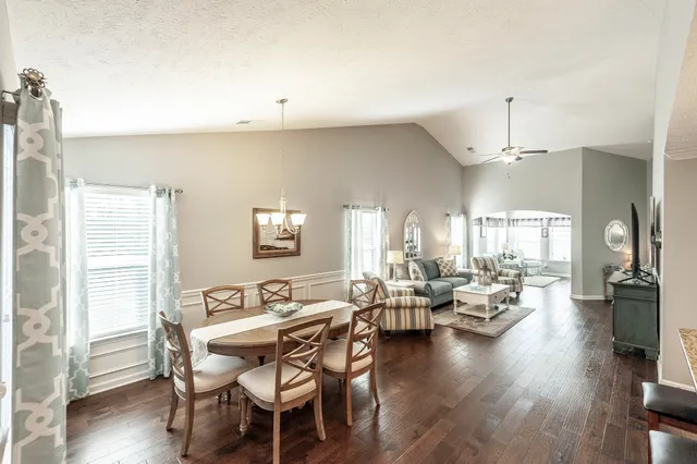 a kitchen with a stove a refrigerator a sink dishwasher with wooden floor and cabinets