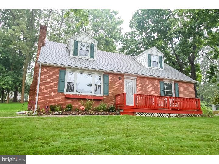 115 Brookside Road Newtown Square, PA 19073 - Photo 1 of 24 a front view of a house with a garden and yard
