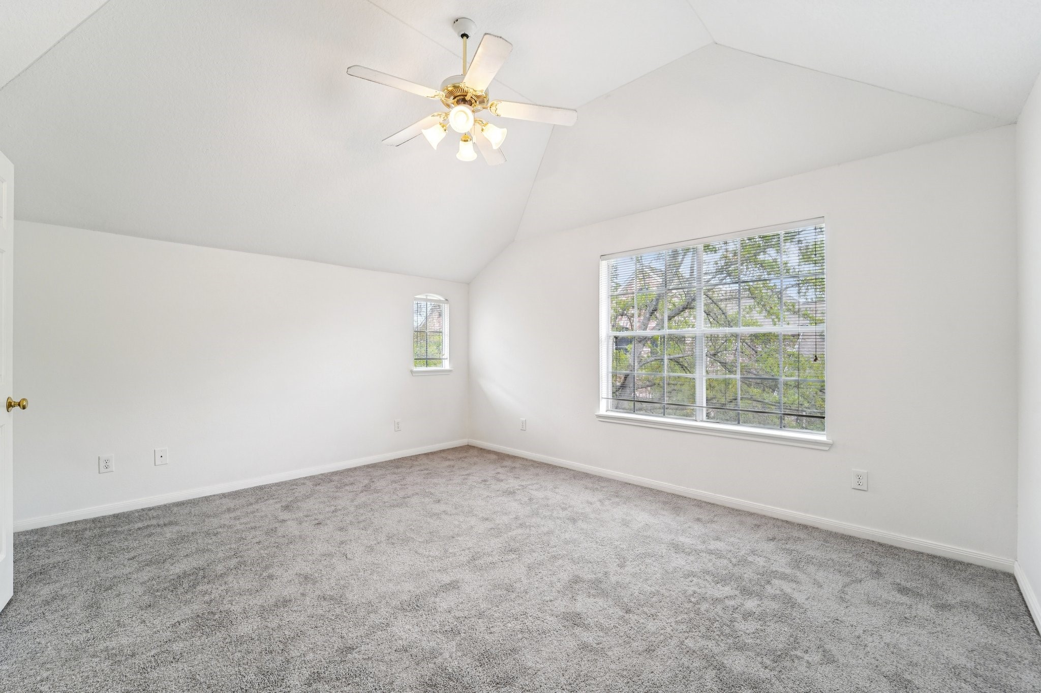 14420 Walters Road, Unit 55 Houston, TX 77014 - Photo 27 of 35 A vaulted ceiling, neutral carpet, and large windows offering plenty of natural light. Ideal for a bedroom or office space.