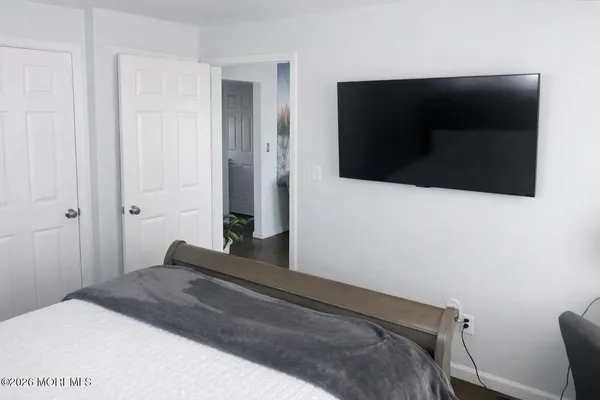 a bedroom with a bed and a shower
