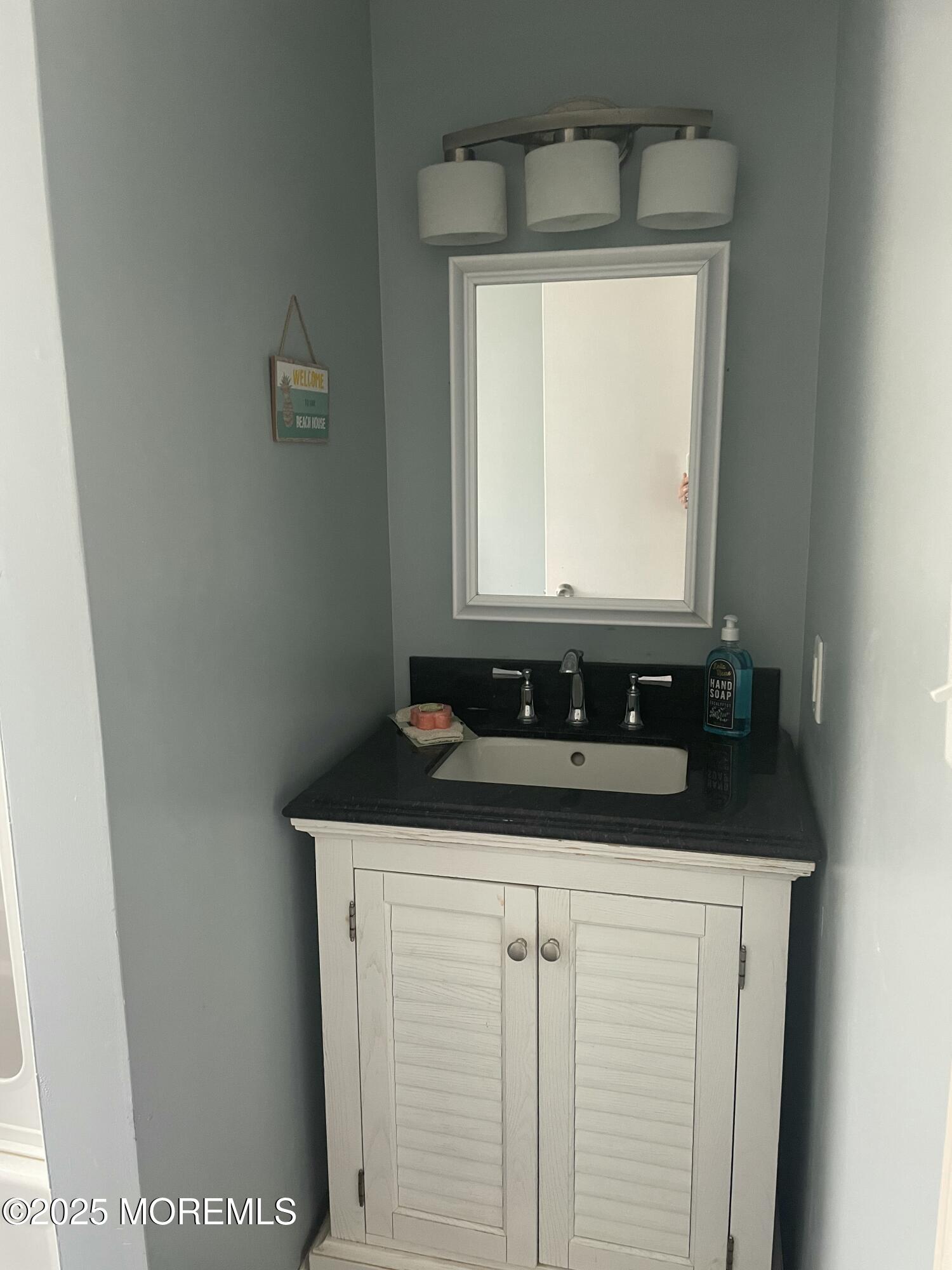 1510 R Bay Boulevard Seaside Heights, NJ 08751 - Photo 29 of 34 a bathroom with a granite countertop sink and mirror