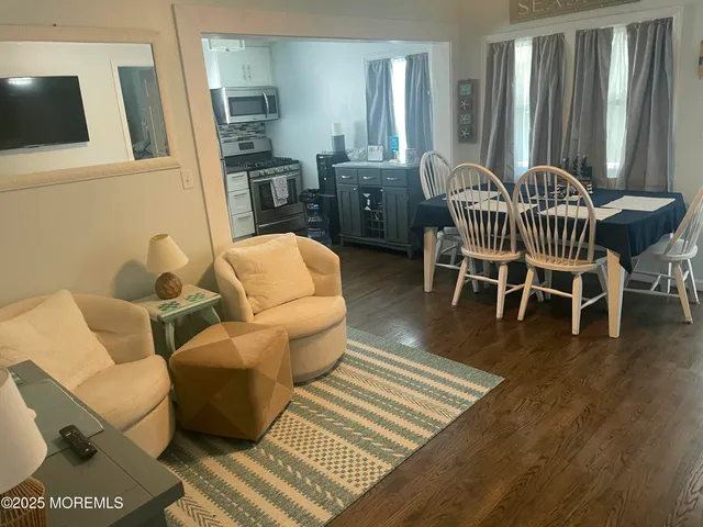 a view of a livingroom with furniture window and wooden floor
