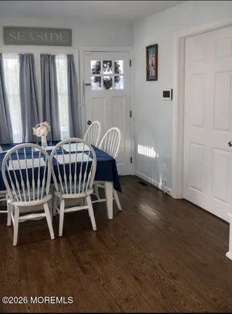 a bedroom with a bed and a flat tv screen on dresser