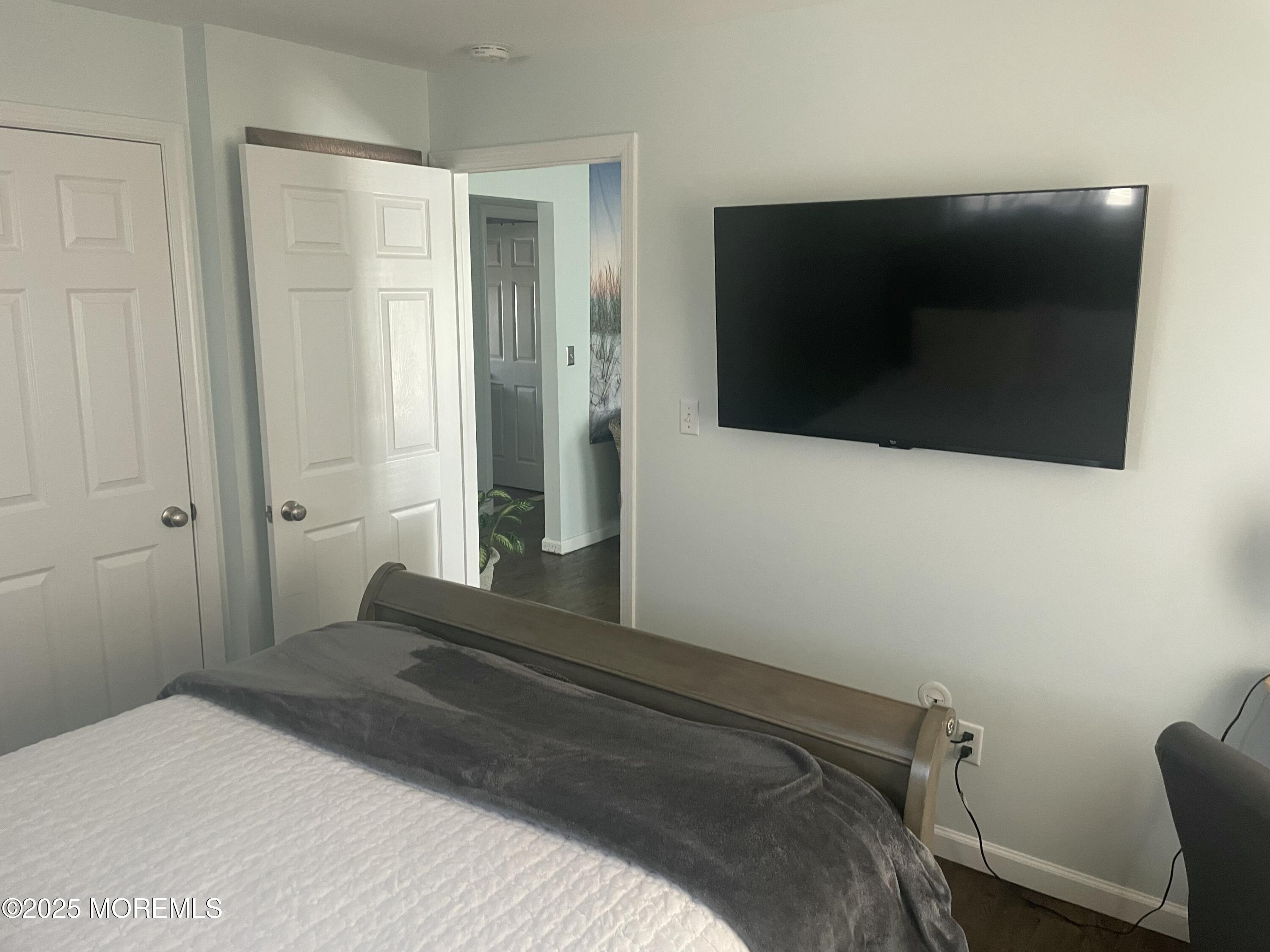 1510 R Bay Boulevard Seaside Heights, NJ 08751 - Photo 10 of 34 a bedroom with a bed and a flat screen tv