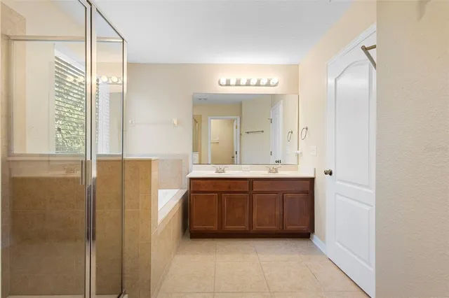 a bathroom with a double vanity sink and a mirror