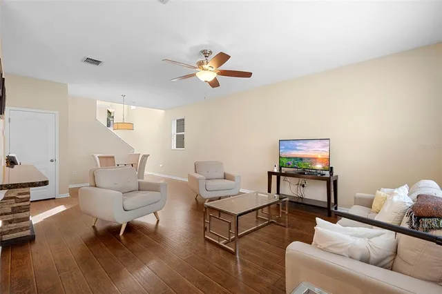 a living room with furniture a rug and a flat screen tv