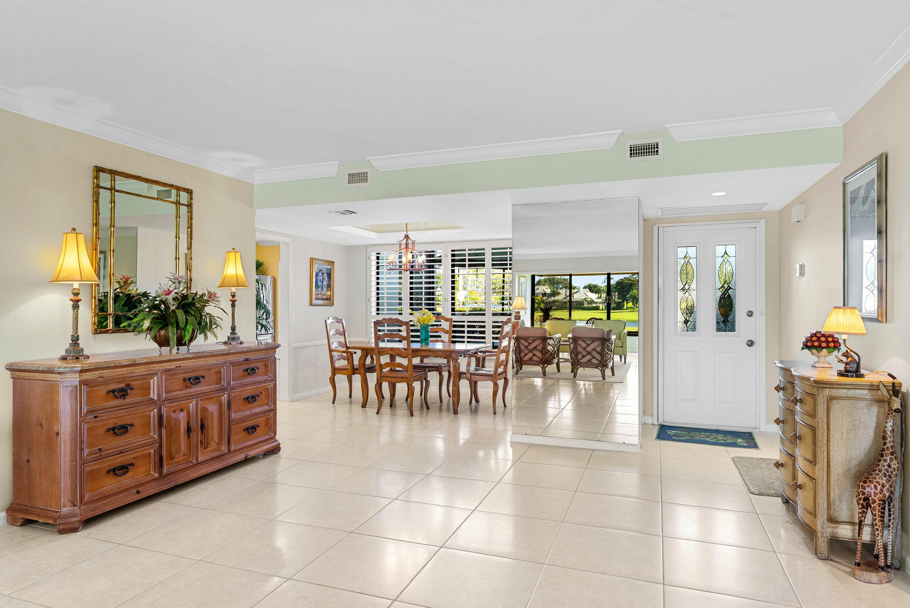 10865 Quail Covey Road, Unit AZALEA Boynton Beach, FL 33436 - Photo 15 of 55 a room with lots of white furniture a chandelier and a view of living room