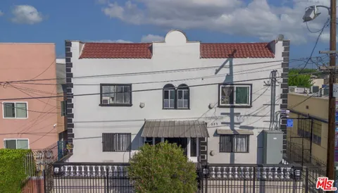 a view of a white building with many windows