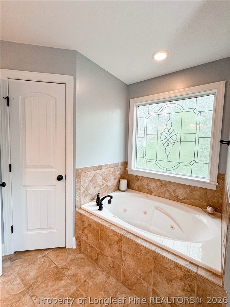 93 Falcon Ridge Drive Spring Lake, NC 28390 - Photo 23 of 50 a bathroom with a bathtub and shower