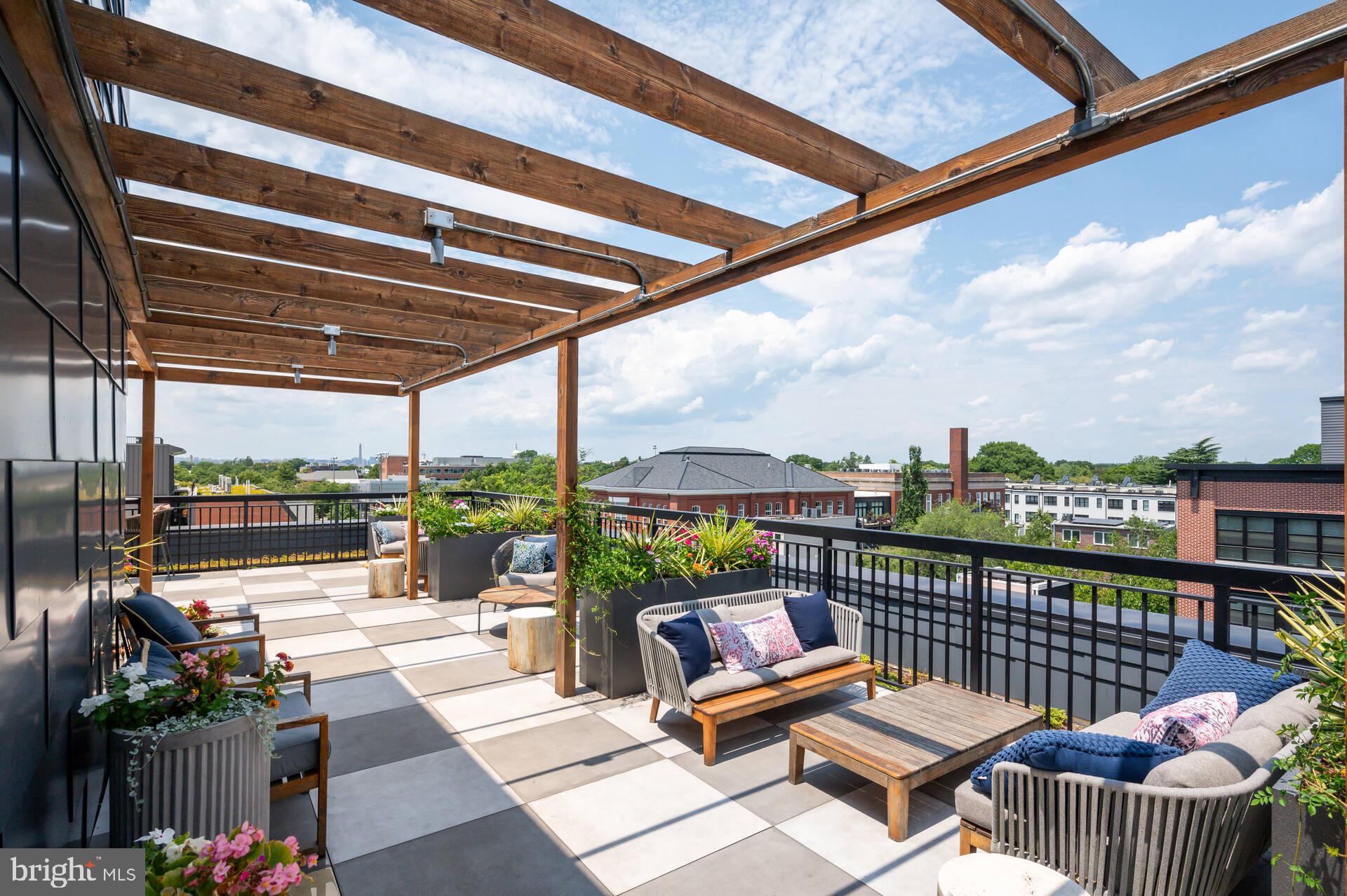 1339 E Street Southeast, Unit 309 Washington, DC 20003 - Photo 2 of 35 a view of a roof deck with a potted plant and sitting area