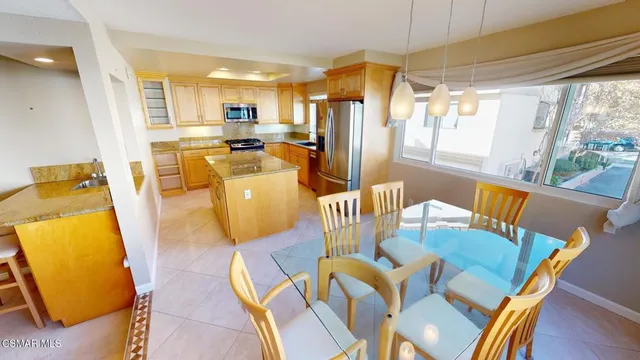 a view of a dining room with furniture a chandelier and wooden floor