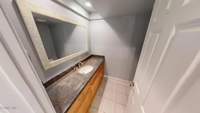 a bathroom with a sink a mirror and a shower