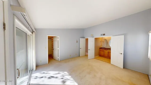 a bathroom with a granite countertop sink mirror vanity and toilet
