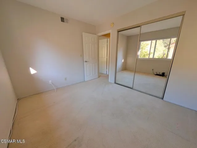 a bathroom with a granite countertop sink mirror vanity and toilet