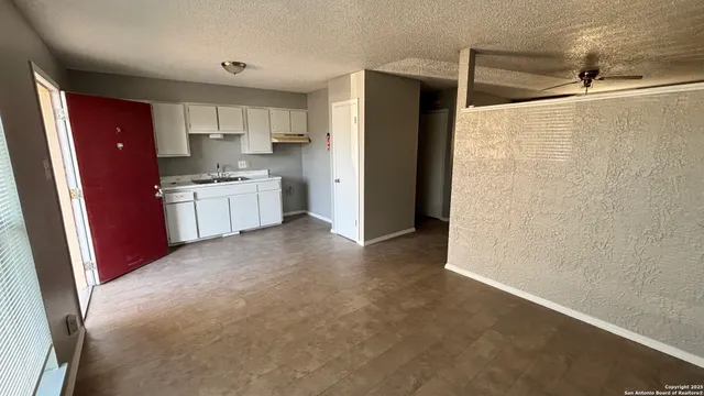 a utility room with wooden floor washer and dryer