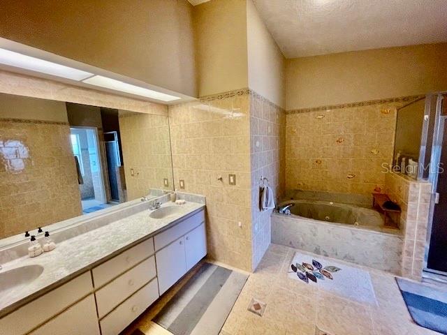 30 San Rafael Court Palm Coast, FL 32137 - Photo 27 of 32 a bathroom with a tub sink and mirror