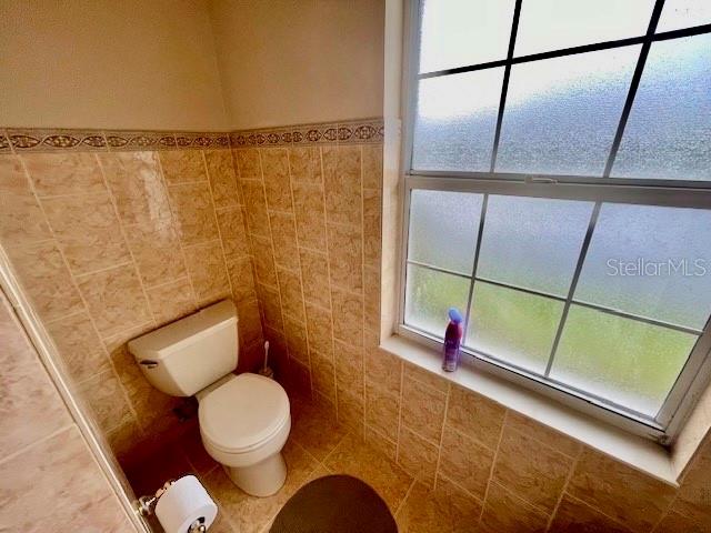 30 San Rafael Court Palm Coast, FL 32137 - Photo 28 of 32 a bathroom with a toilet and a mirror