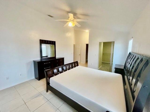 30 San Rafael Court Palm Coast, FL 32137 - Photo 29 of 32 a bedroom with a bed and a flat screen tv