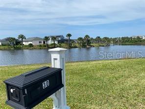 30 San Rafael Court Palm Coast, FL 32137 - Photo 8 of 32 a view of a lake with houses in the back