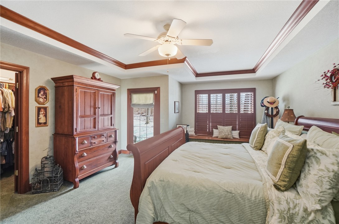 5300 Brookshire Lane Springfield, OH 45502 - Photo 26 of 56 This primary bedroom features a tray ceiling, recessed lighting, and a walk-in closet for ample storage.