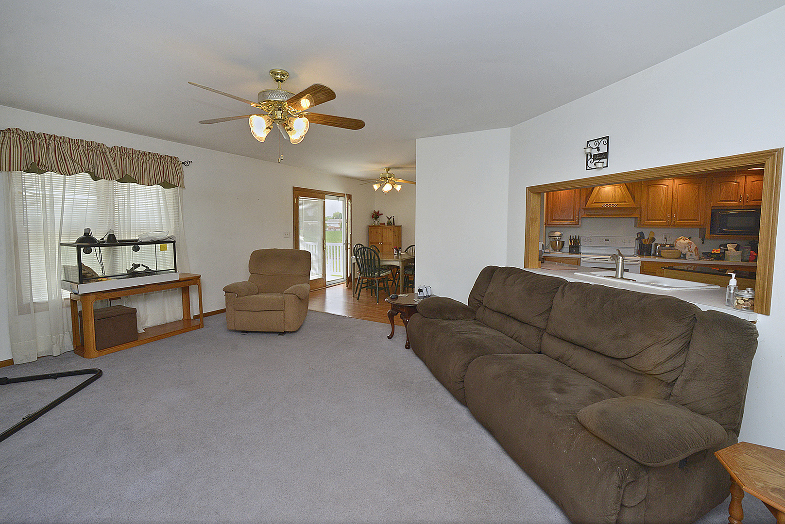 2098 North 15th Road Streator, IL 61364 - Photo 3 of 23 a living room with furniture a chandelier and a flat screen tv