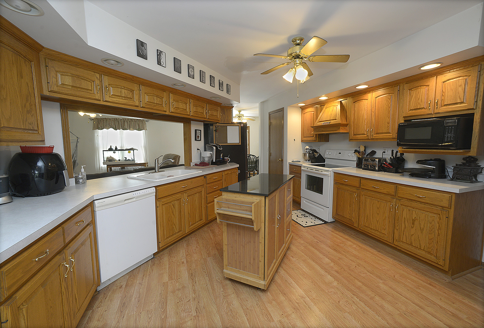2098 North 15th Road Streator, IL 61364 - Photo 4 of 23 a kitchen with a sink cabinets and wooden floor