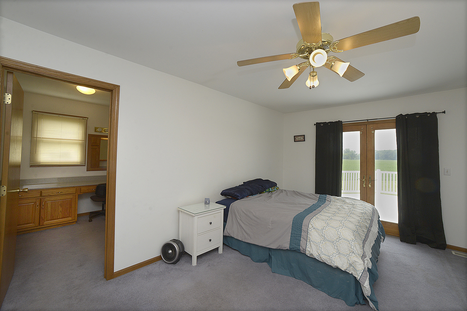 2098 North 15th Road Streator, IL 61364 - Photo 8 of 23 a bedroom with a bed and a chandelier