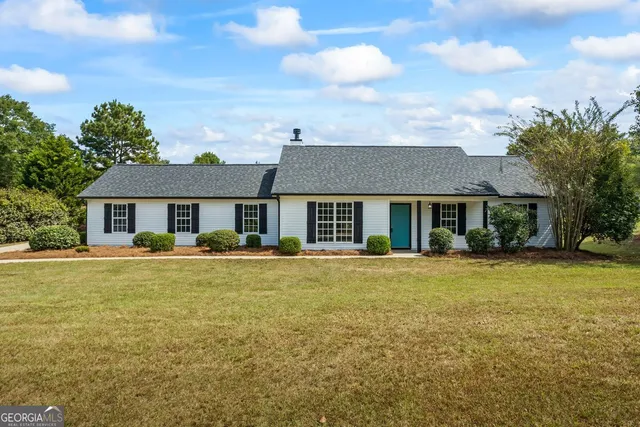 a front view of a house with a garden