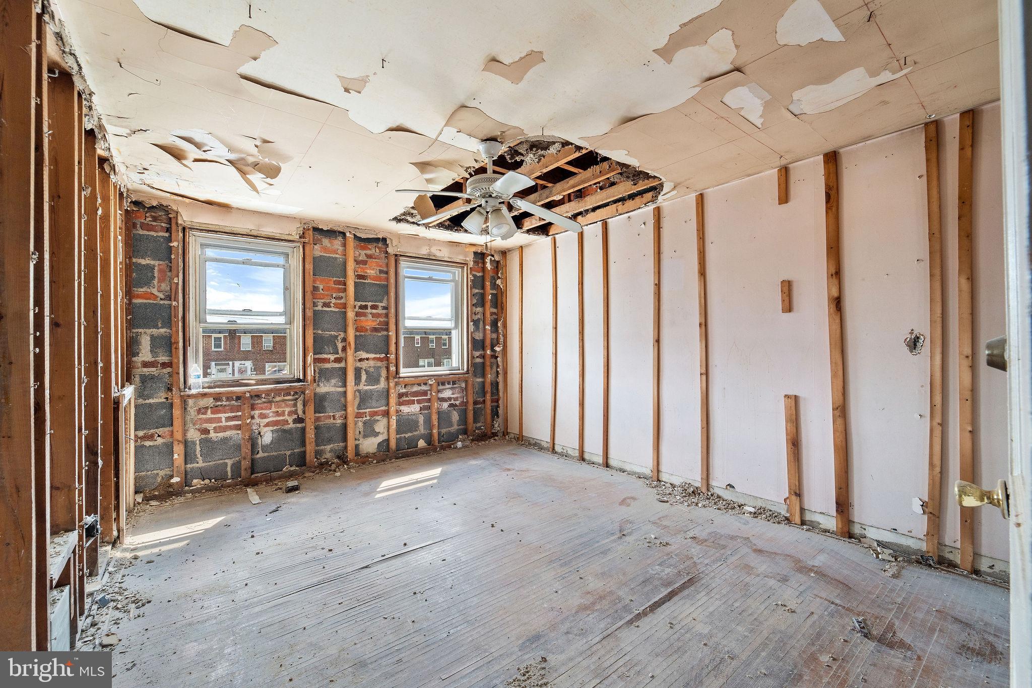 642 Randolph Street Camden, NJ 08105 - Photo 14 of 24 an empty room with windows and ceiling fan