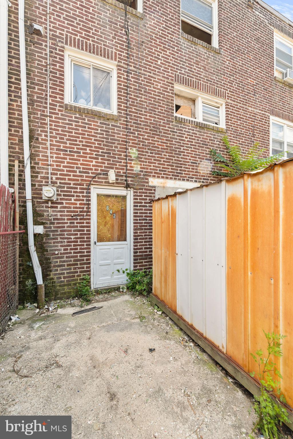 642 Randolph Street Camden, NJ 08105 - Photo 23 of 24 a view of a brick house with many windows