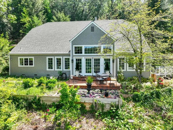 a house with potted plants in front of it