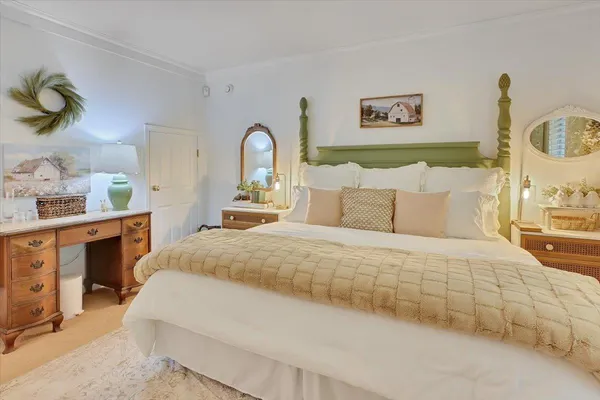 a view of a patio with table and chairs potted plants and large tree