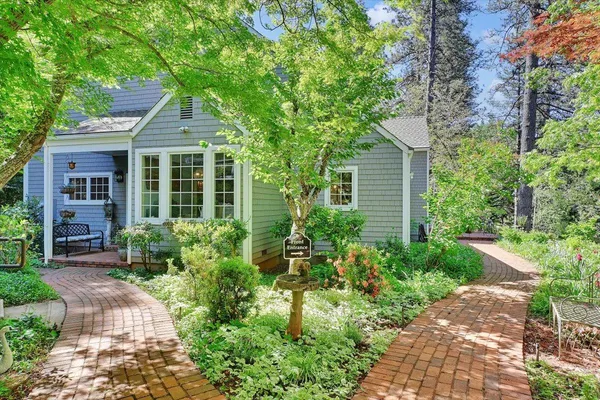 a view of a patio with table and chairs and potted plants
