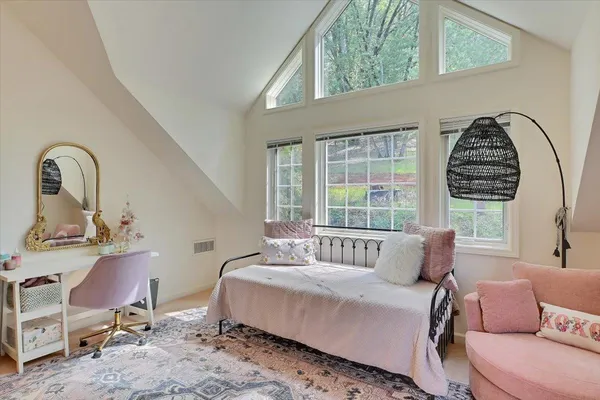 a spacious bedroom with a large bed and furniture