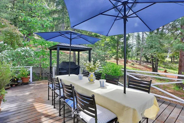 a living room with stainless steel appliances furniture stove top oven and a table