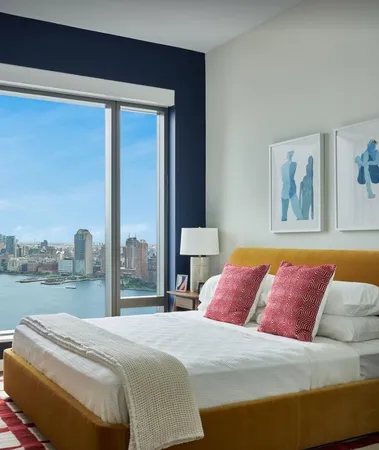 a bedroom with a large bed and a large window