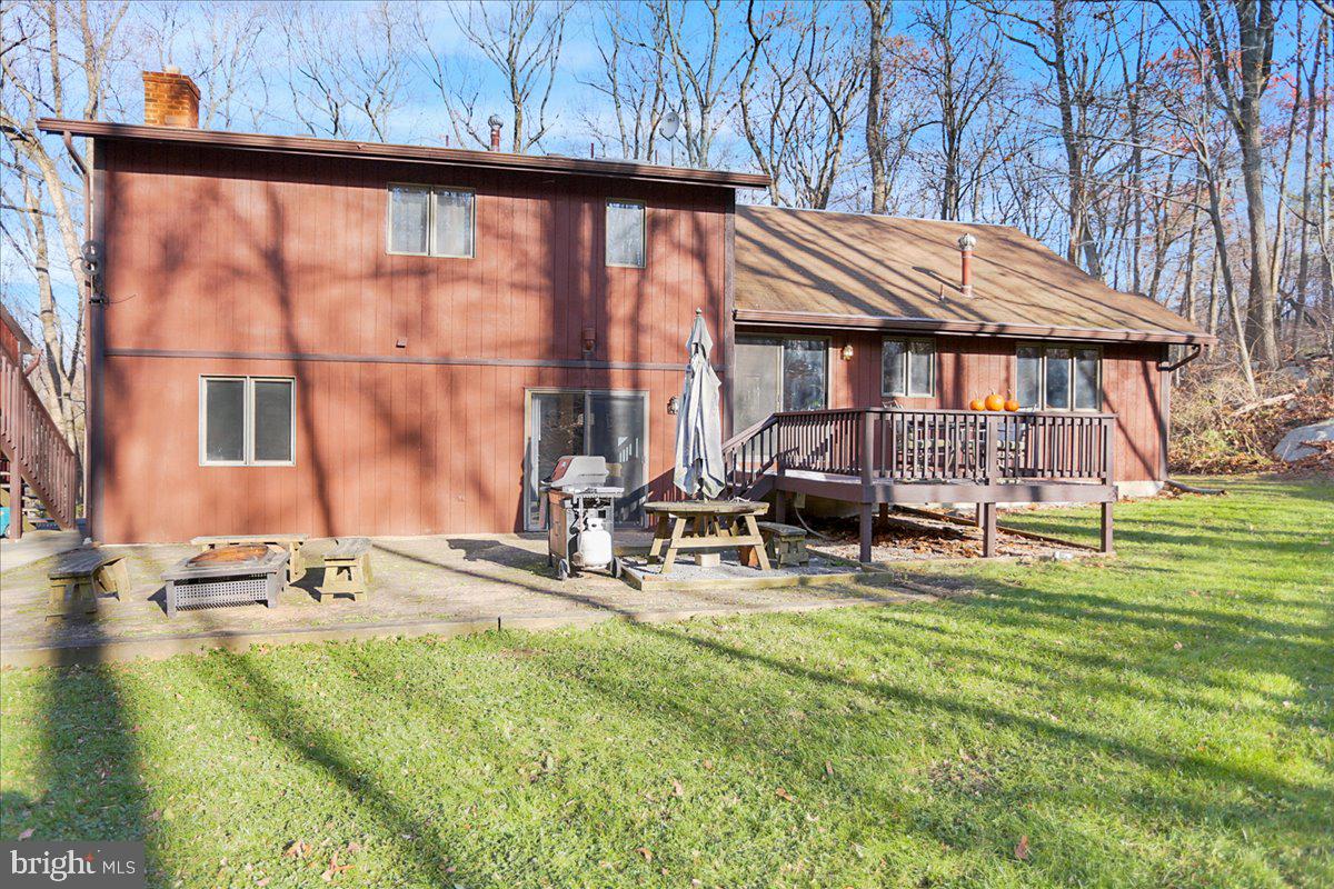 Back of home with deck and patio area