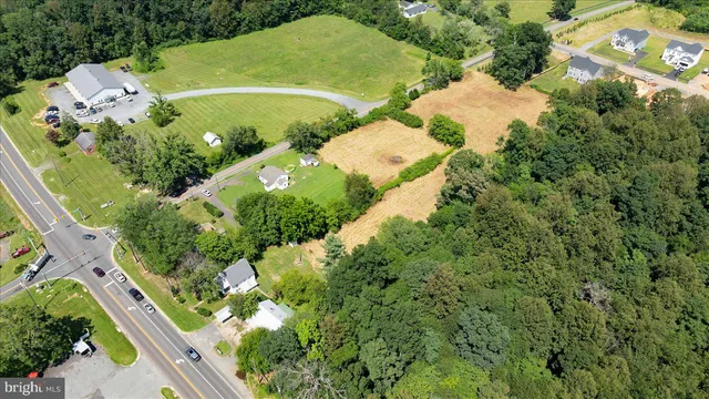 an aerial view of a residential houses with outdoor space