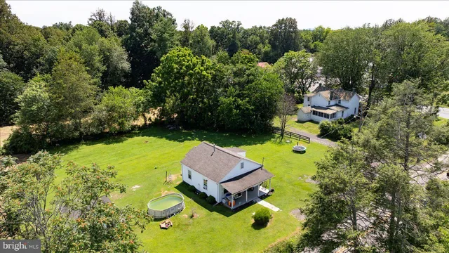 a aerial view of a house with a yard basket ball court and outdoor seating