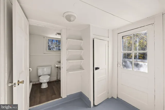 a kitchen with cabinets and wooden floor
