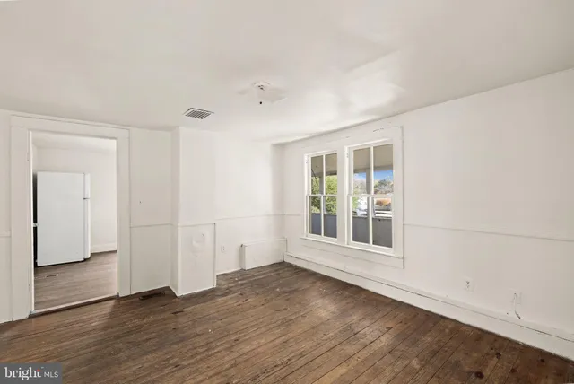 a kitchen with a stove and white cabinets